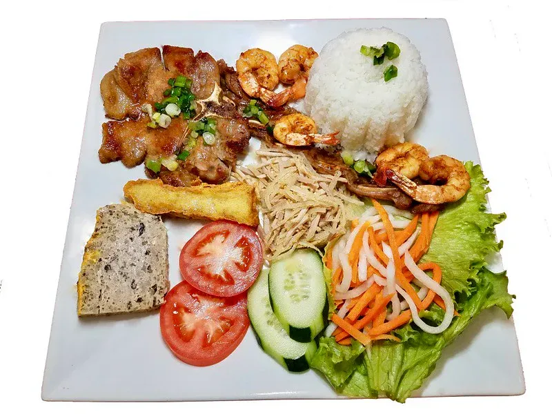 Grilled lemongrass pork chop with a fried egg over steamed rice